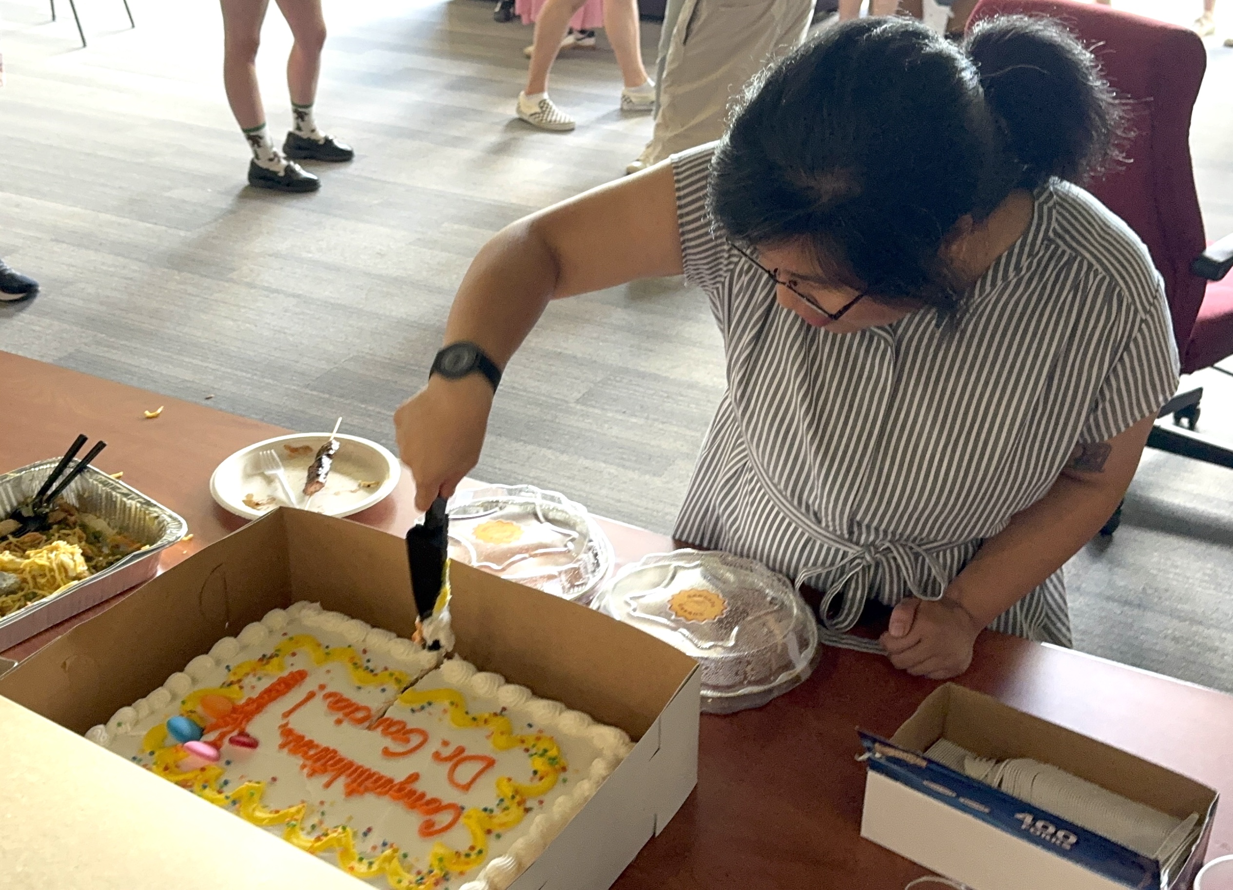 Jane Garcia cuts cake post-defense
