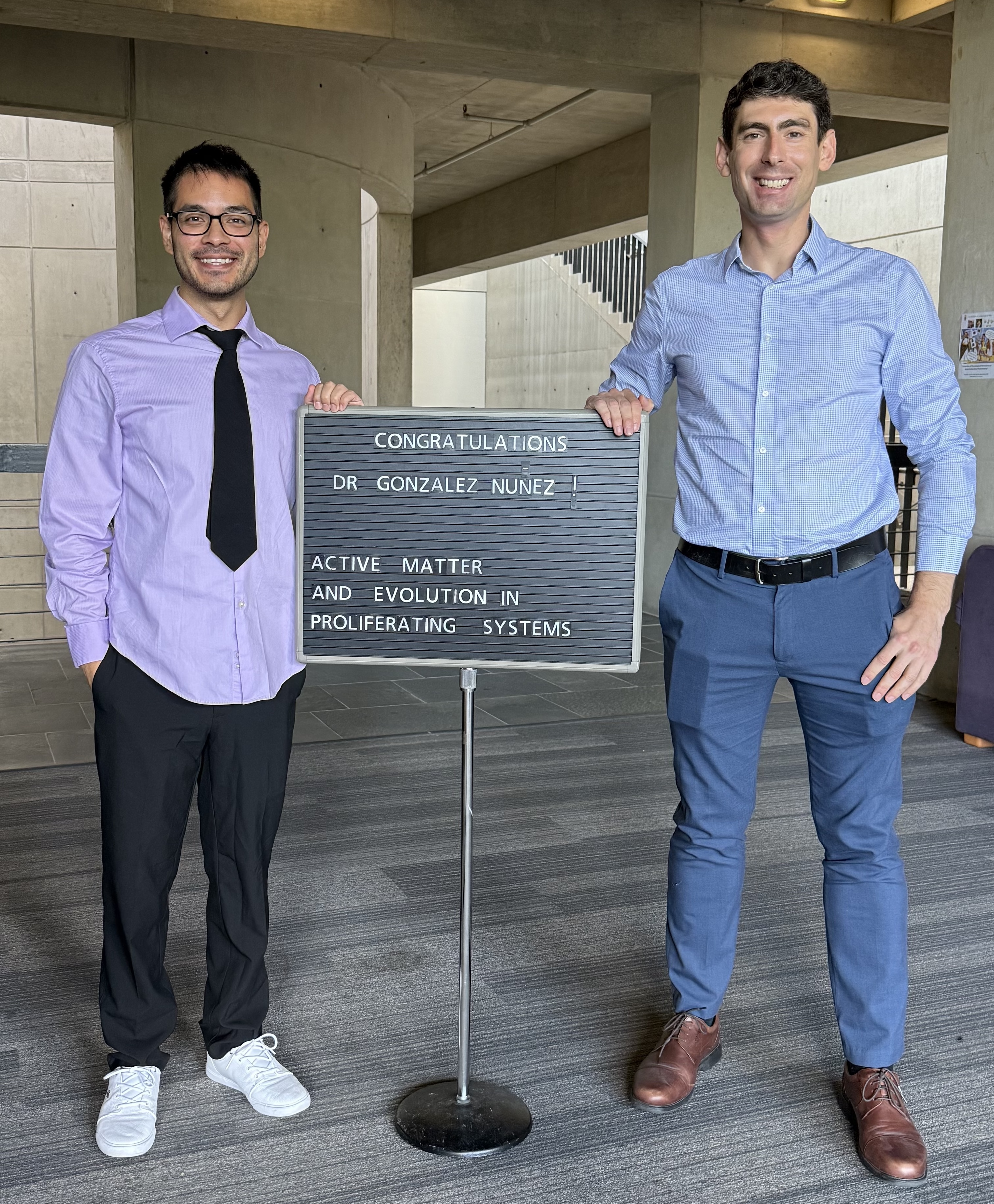 Jimmy and Dan with sign celebrating Jimmy's defense